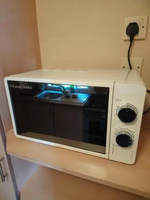 a microwave oven sitting on top of a wall at The Franklin in Saint Osyth