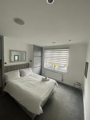 a bedroom with a white bed and a window at Cozy Town Centre 2 Bed Apartment Close To Historic Landmarks And Great Restaurants in Ipswich