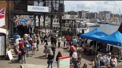 a crowd of people walking on a pier near a marina at Cozy Town Centre 2 Bed Apartment Close To Historic Landmarks And Great Restaurants in Ipswich
