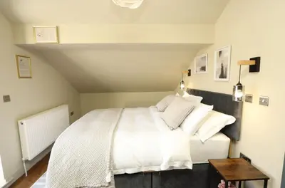 a bedroom with a bed with white sheets and pillows at Modern 2 Bed 2 Bath Apartment In Colchester, Walk To Town Center & Station in Colchester