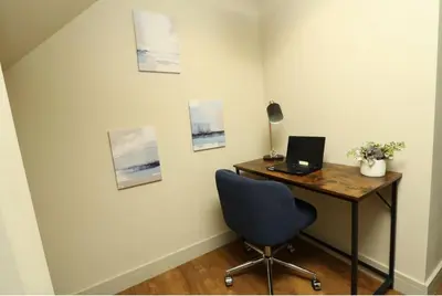 a desk with a laptop and a chair in a room at Modern 2 Bed 2 Bath Apartment In Colchester, Walk To Town Center & Station in Colchester