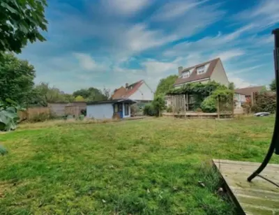 a house in a yard with a grass field at double bed short stay cabin in Martlesham