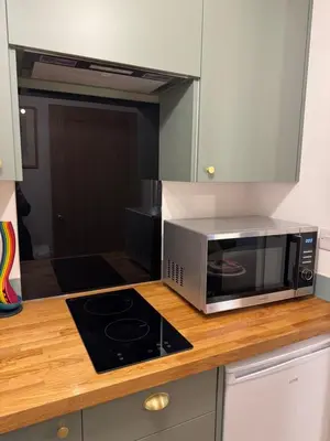 a microwave oven sitting on a counter in a kitchen at Poets View - Studio in Honington, Suffolk in Honington