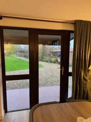 a sliding glass door with a view of a yard at Poets View - Studio in Honington, Suffolk in Honington