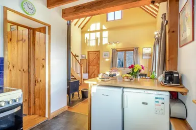 a kitchen with a white refrigerator and a counter at 1 Bed in Orford oc-m34121 in Orford