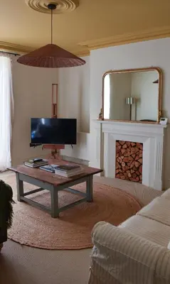 a living room with a coffee table and a mirror at Sunray House - Sea View, Beach Front Holiday Home in Felixstowe