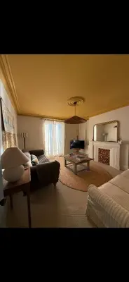 a large living room with a couch and a table at Sunray House - Sea View, Beach Front Holiday Home in Felixstowe