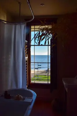 a room with a window with a view of the ocean at Sunray House - Sea View, Beach Front Holiday Home in Felixstowe