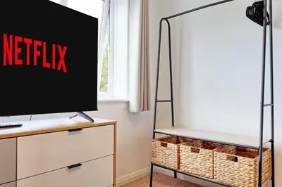 a television on a dresser with a netflix sign on it at Premium 5-Bed Home, Garden, Parking & High-Speed Wi-Fi in Nevendon