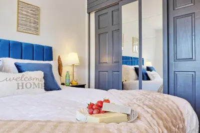 a bedroom with a bed with a box of fruit on it at Premium 5-Bed Home, Garden, Parking & High-Speed Wi-Fi in Nevendon