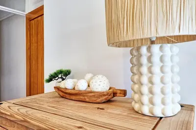 a table with a lamp and a bowl of eggs at Cosy 2 Bedroom Flat Near Westcliff On Sea Beach & Hamlet Court Road in Southend-on-Sea