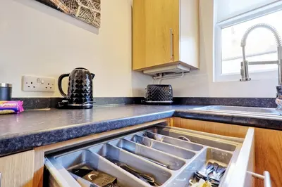 a kitchen sink with an open drawer in it at Cosy 2 Bedroom Flat Near Westcliff On Sea Beach & Hamlet Court Road in Southend-on-Sea