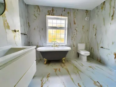a bathroom with a claw foot tub and a toilet at Green Rig