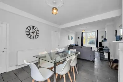 a dining room and living room with a table and chairs at 17 OutRisbygate St - 3 bedroom house that sleeps 6 with one private parking space in Bury Saint Edmunds