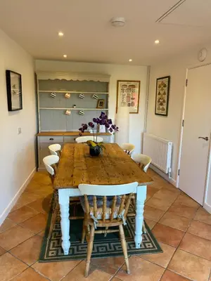 a dining room with a wooden table and chairs at Entire flat 2 to 4 pers 1 bed 1 bath disabled access for limited disability