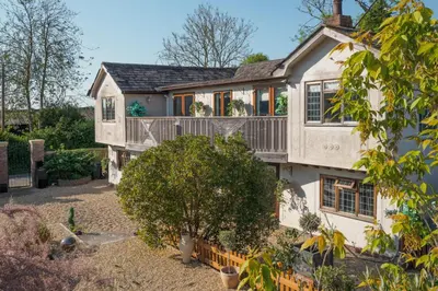 an exterior view of a house with a balcony at Sampford Hideaway Retreat in Great Sampford