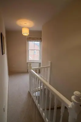 an empty room with a staircase and a window at 3 bed Victorian terrace 10mins walk from Colchester city centre in Colchester