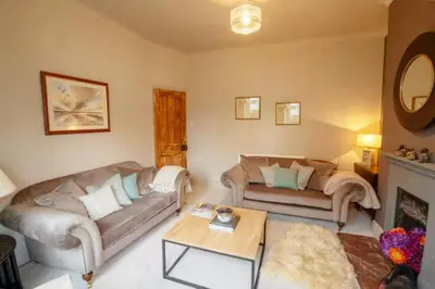 a living room with a couch and a table at 3 bed Victorian terrace 10mins walk from Colchester city centre in Colchester