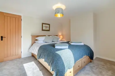 a bedroom with a bed with a blue blanket at 2 Bed in Ashley oc-c32637