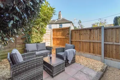 a patio with two chairs and a table and a fence at 2 Bed in Ashley oc-c32637