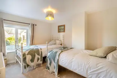 a bedroom with two beds and a window at 2 Bed in Ashley oc-c32637