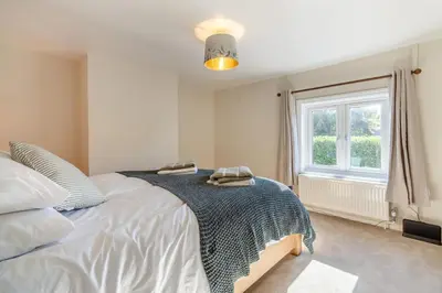 a bedroom with a large bed and a window at 2 Bed in Ashley oc-c32637