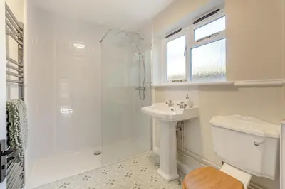 a white bathroom with a shower and a sink at 2 Bed in Ashley oc-c32637