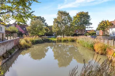 a river in a town with trees and houses at 2 Bed in Ashley oc-c32637