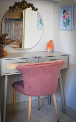 a pink chair in front of a desk with a mirror at Daisy Cottage - Framlingham in Framlingham