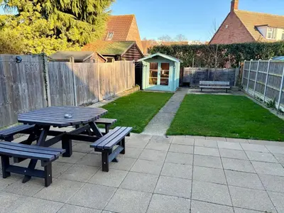 a picnic table and benches in a backyard at City Centre, En-Suite, 3 Doubles 1 Single, 2 Car Parking in Colchester