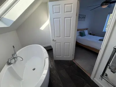 a bathroom with a toilet and a sink and a bed at City Centre, En-Suite, 3 Doubles 1 Single, 2 Car Parking in Colchester