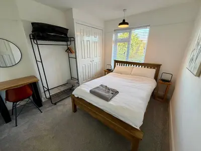 a bedroom with a bed and a desk and a window at City Centre, En-Suite, 3 Doubles 1 Single, 2 Car Parking in Colchester