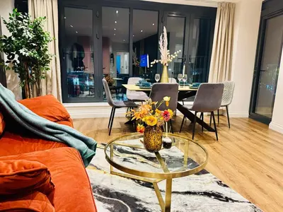 a living room with a glass table with flowers on it at Lux 2 Bedroom Flat Central Brentwood slp 8 Guests in Brentwood
