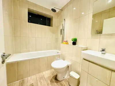 a bathroom with a toilet and a tub and a sink at Lux 2 Bedroom Flat Central Brentwood slp 8 Guests in Brentwood
