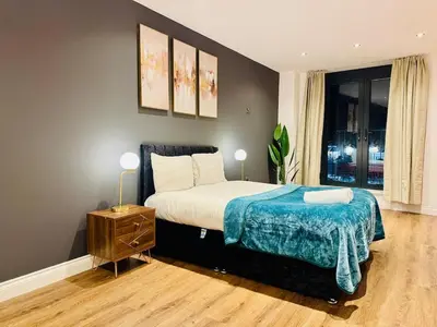 a bedroom with a bed and a nightstand and a window at Lux 2 Bedroom Flat Central Brentwood slp 8 Guests in Brentwood