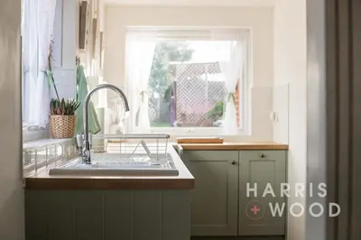a kitchen with a sink and a window at Vine Cottage in Chelmondiston