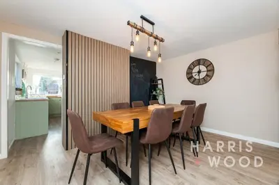 a dining room with a wooden table and chairs at Vine Cottage in Chelmondiston