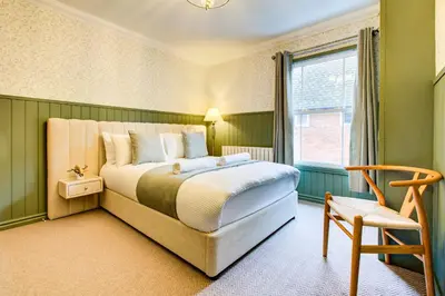 a bedroom with a bed and a window and a chair at Cottage in the centre in Colchester