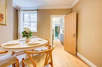 a dining room with a table and chairs at Cottage in the centre in Colchester