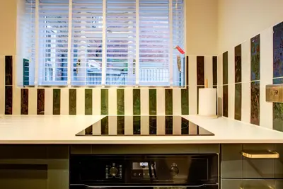 a kitchen with a counter and a stove top oven at Cottage in the centre in Colchester