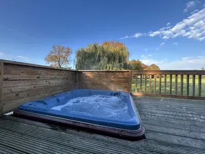 a hot tub sitting on top of a deck at Athelington lodge - Beech in Eye