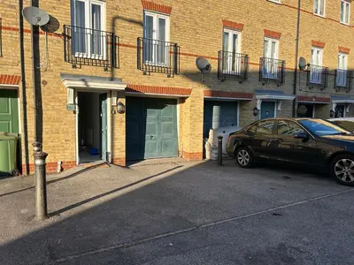 a car parked in front of a brick building at Chartsworth 4 Bedrooms Spacious House in Harold Wood