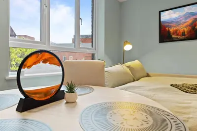 a mirror sitting on a table in a living room at Modern, Quiet & Cozy Flat in Central Chelmsford - F7 in Chelmsford