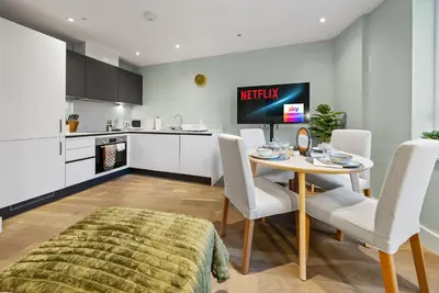 a kitchen and dining room with a table and chairs at Modern, Quiet & Cozy Flat in Central Chelmsford - F7 in Chelmsford