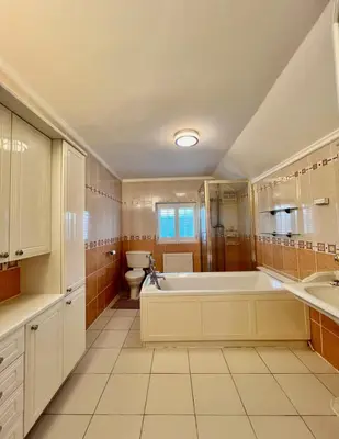 a large bathroom with a tub and a toilet at Three Bees in Hythe