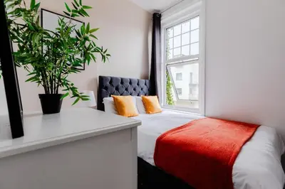 a bedroom with a bed and a window at The Regency | Seafront Lux Apartments! in Southend-on-Sea