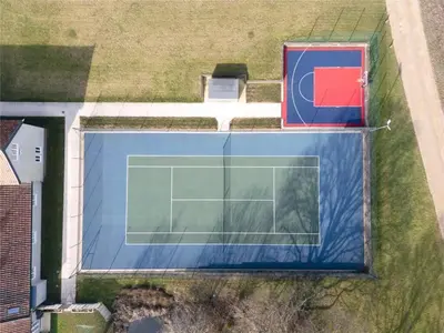 an overhead view of a tennis court in a field at Martley Hall Estate by Group Retreats in Woodbridge