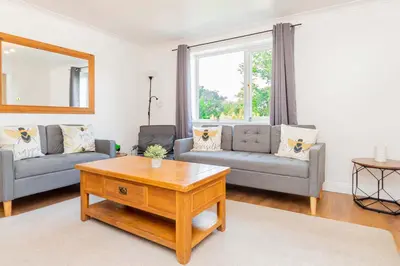 a living room with two couches and a coffee table at Beautiful 3 Bedroom Home with Parking & Garden in Colchester