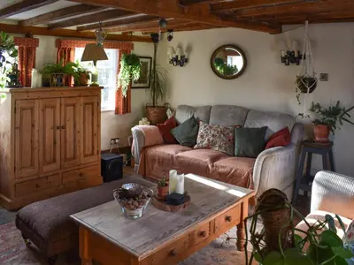 a living room with a couch and a coffee table at Hill House in Colchester