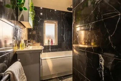 a bathroom with a sink and a bath tub and a sink at Spacious 3-Bed Home for 8 | Free Parking & Garden in Havering atte Bower